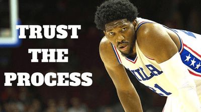 Joel Embiid leaning forward with hands on knees next to the words Trust the Process
